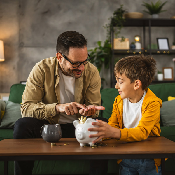 man saving money with son