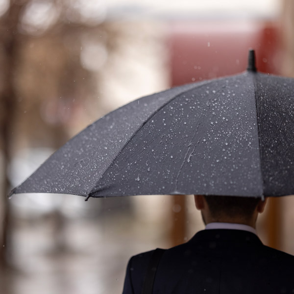 man carrying umbrella